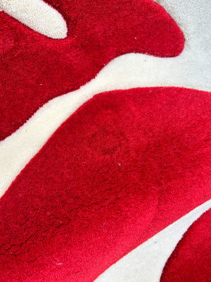 Red woollen carpet with cream squiggles