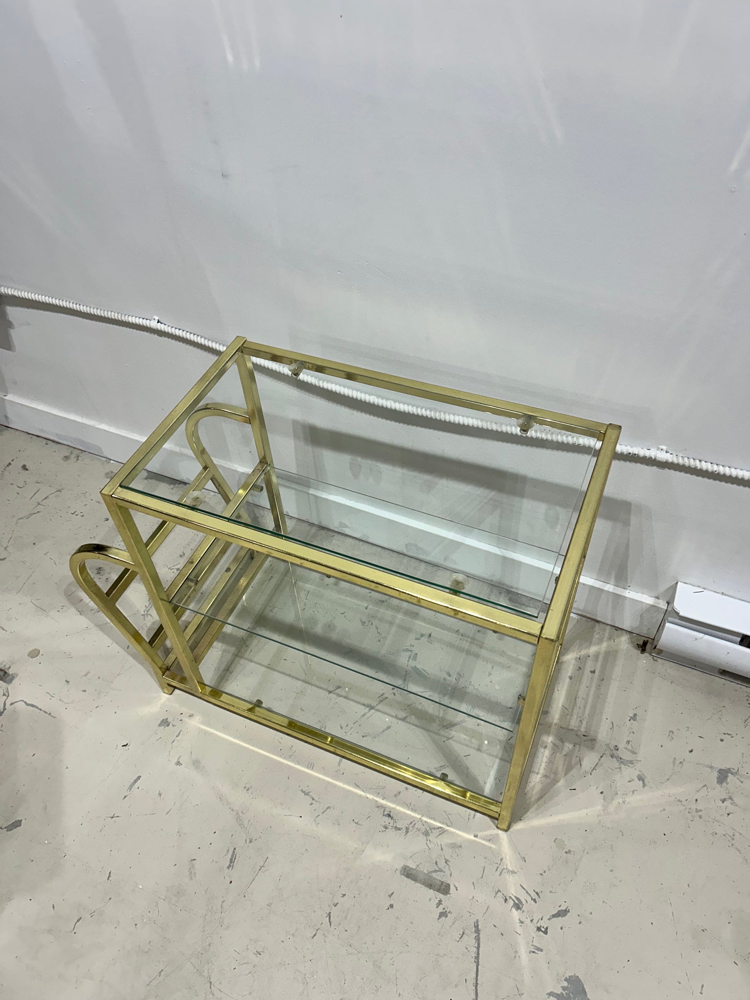 Golden brass side table with literature rack