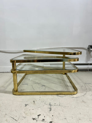 Golden brass & glass square coffee table with triangular swivel tablets