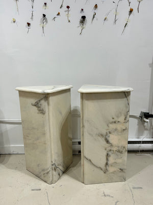 White marble triangular podiums