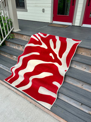 Red woollen carpet with cream squiggles