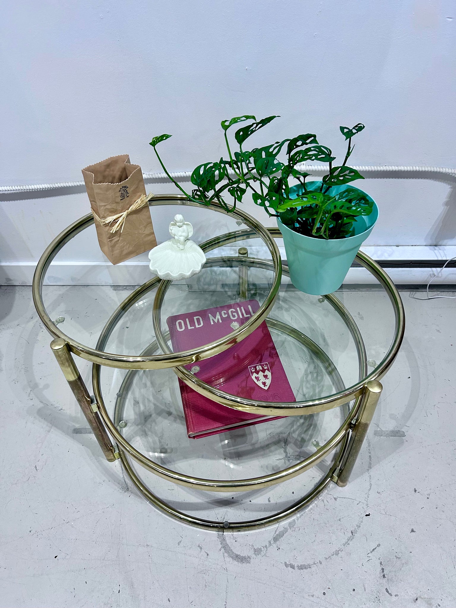 Golden brass & glass round swivel coffee table