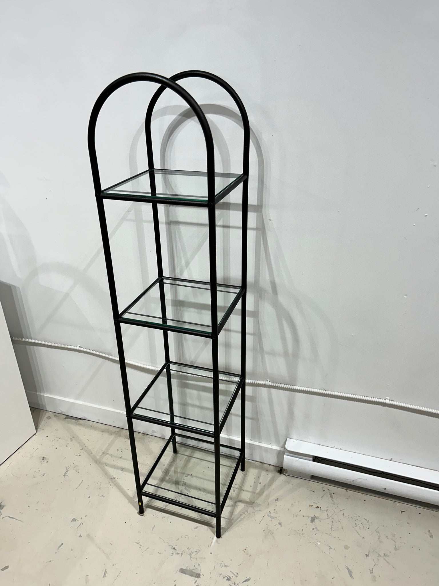 Tall slim black arched shelf