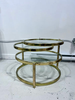 Golden brass & glass round swivel coffee table
