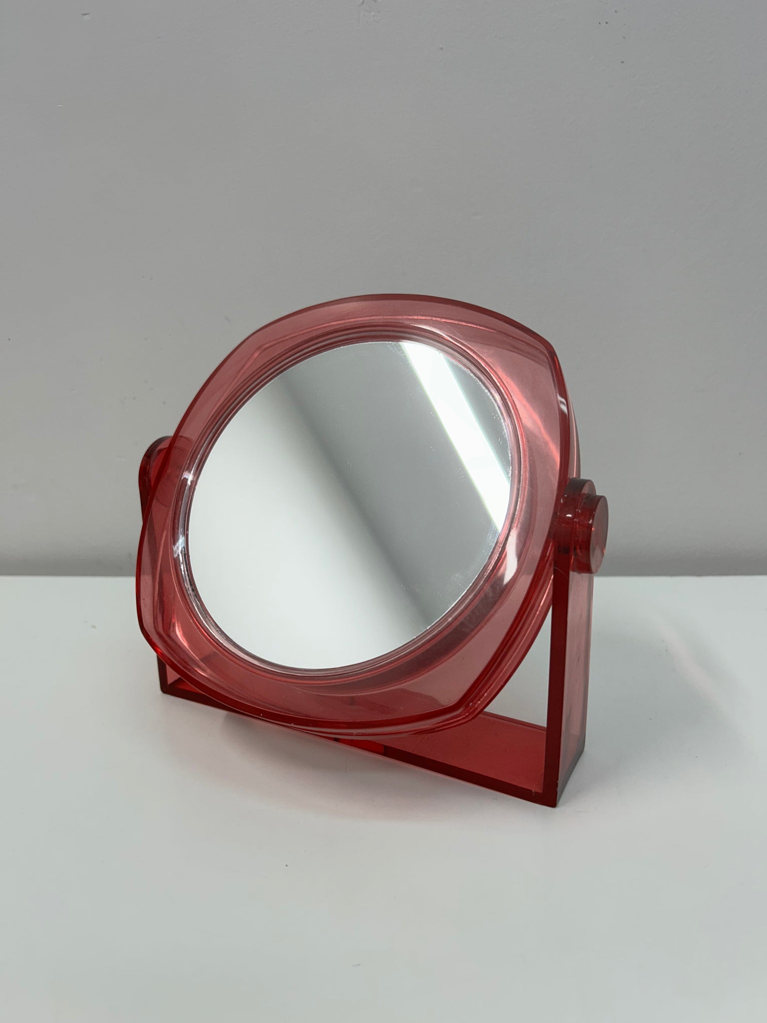 Small plastic fuschia swivel table mirror