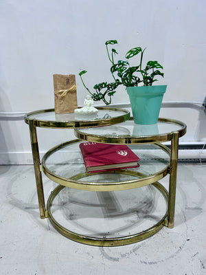 Golden brass & glass round swivel coffee table
