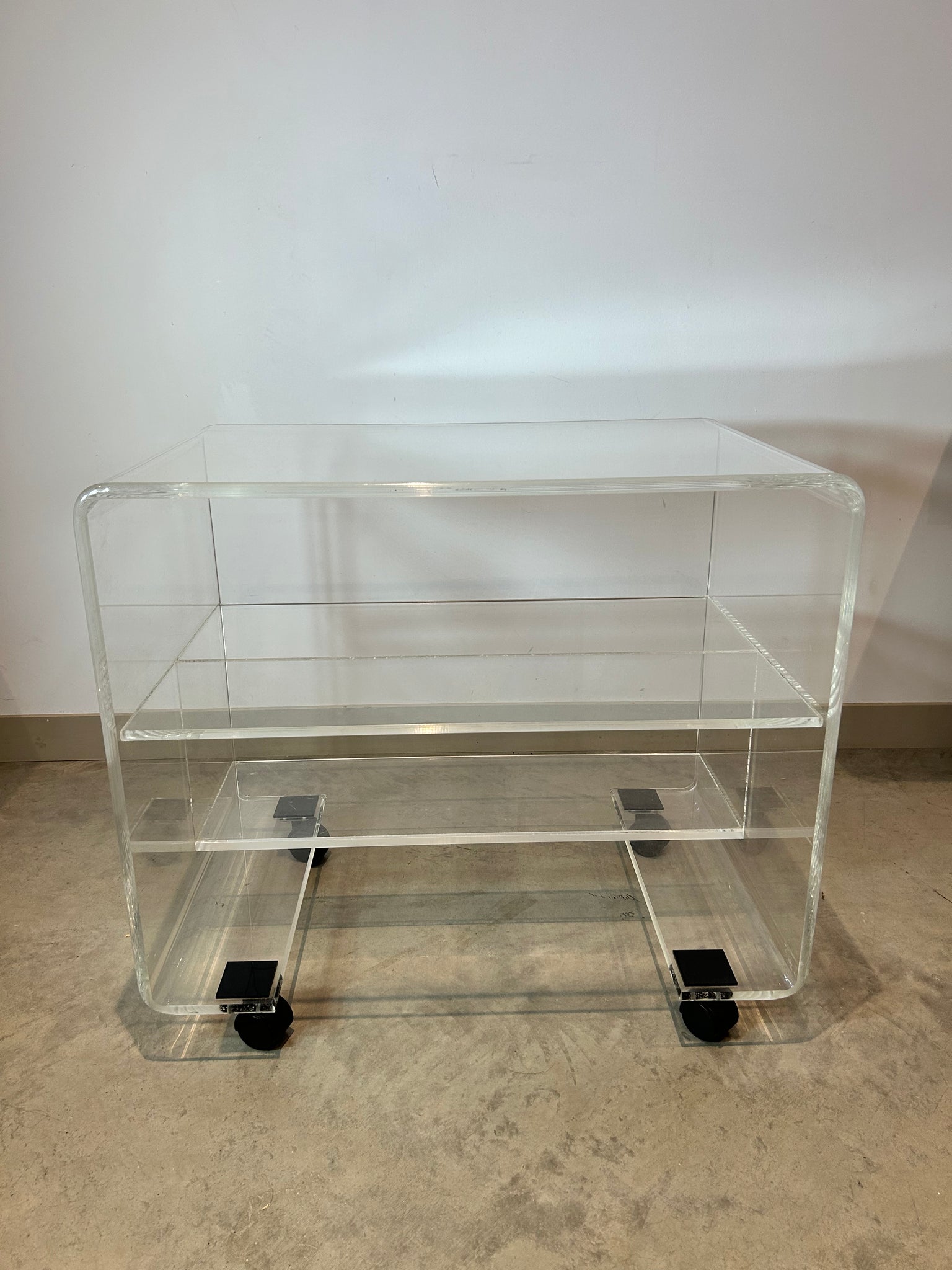 Small lucite coffee / side table on wheels