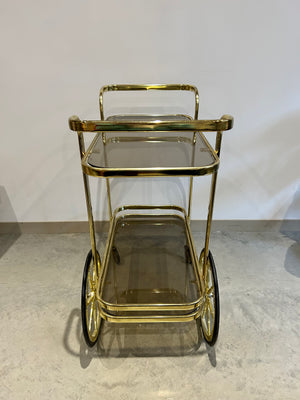 Golden brass bar cart with two handles