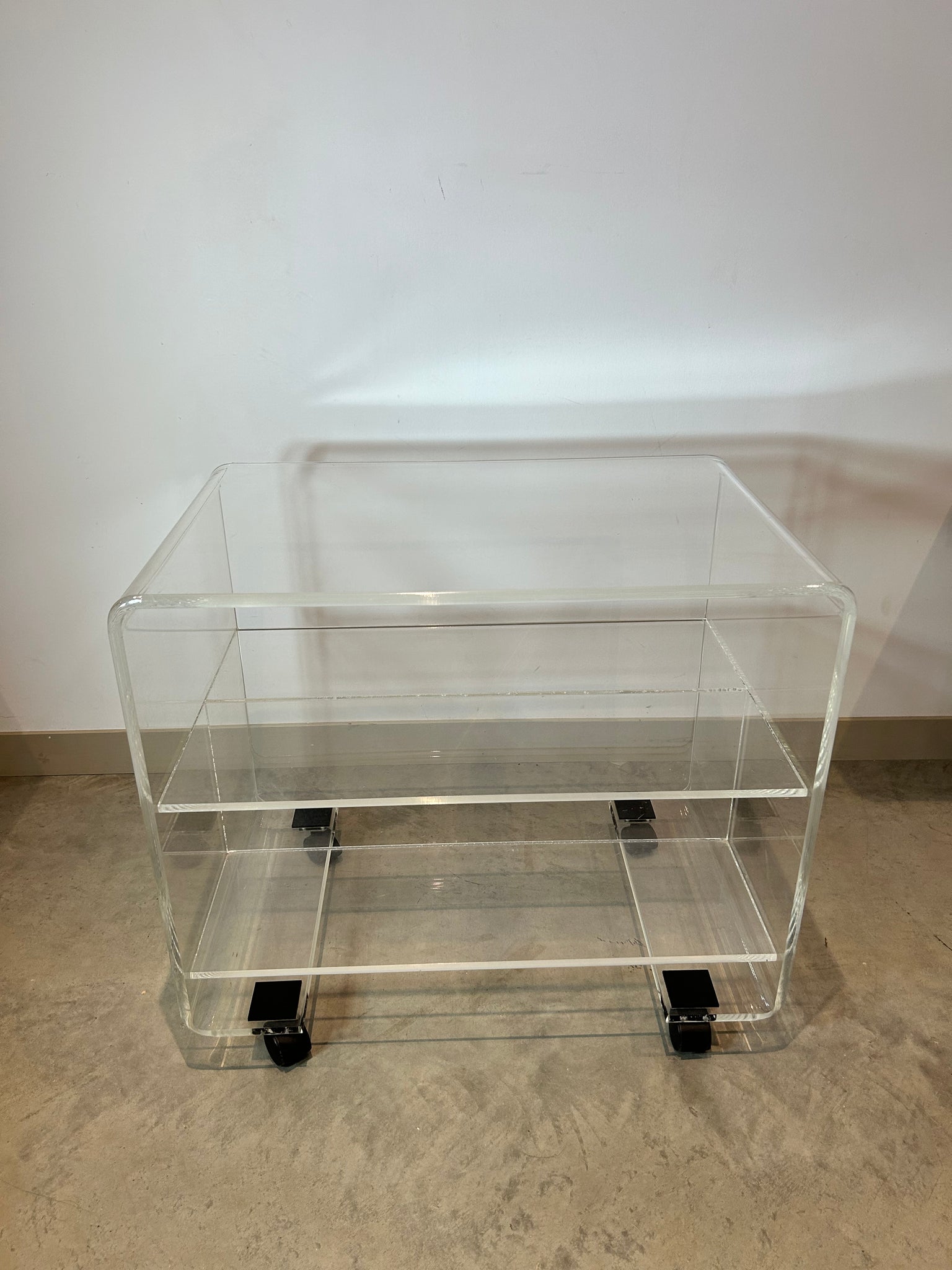 Small lucite coffee / side table on wheels