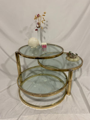 Golden brass & glass round swivel coffee table