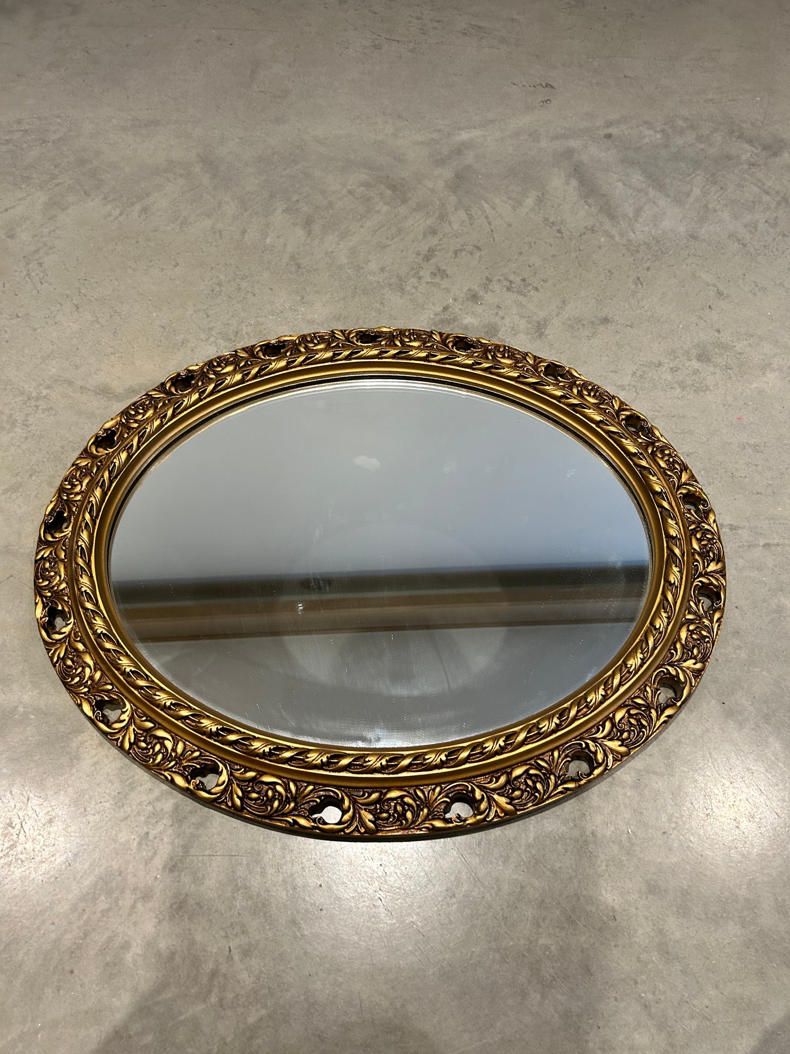 Antique ornate golden oval mirror