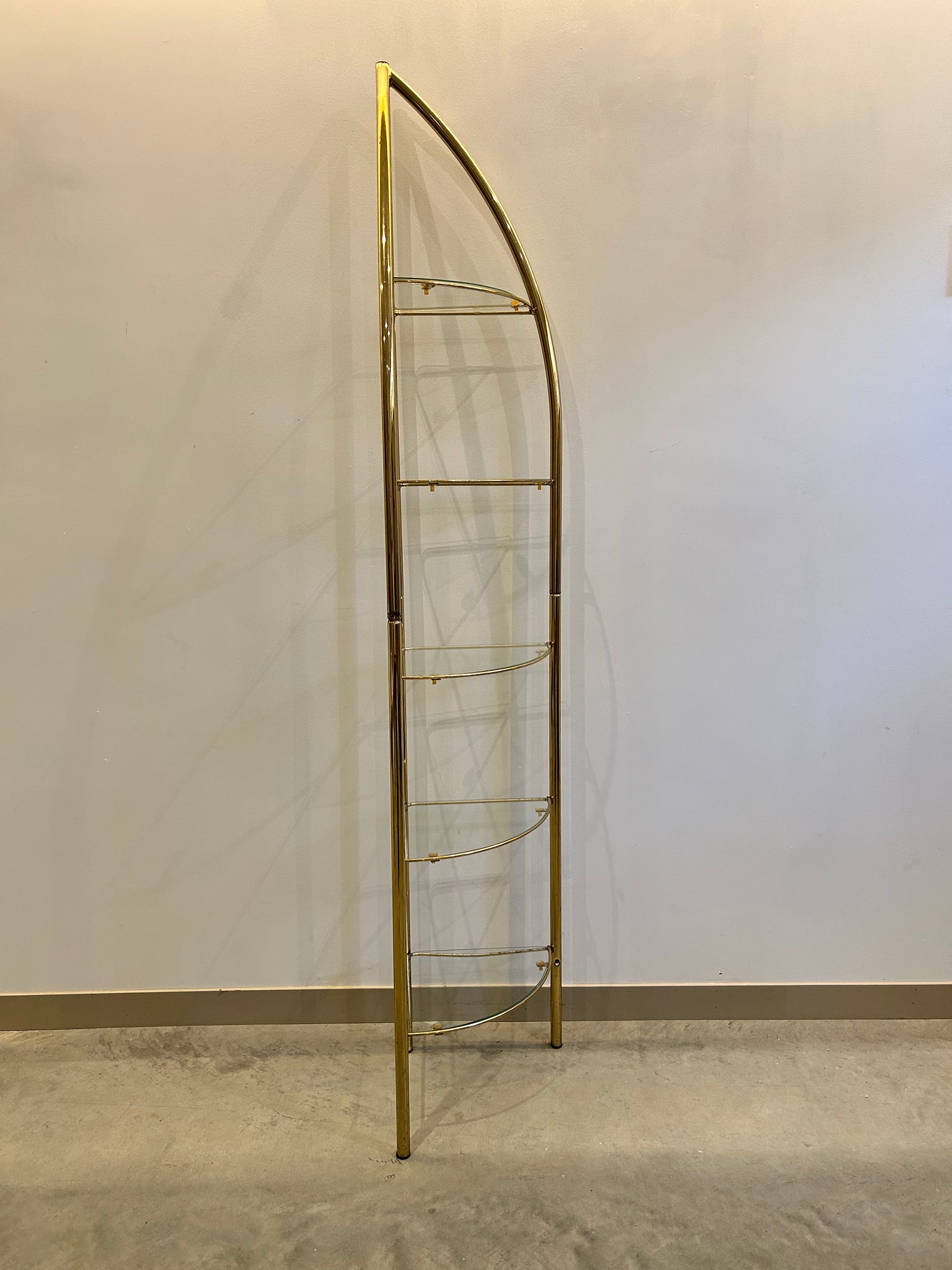 Tall slim golden brass & glass corner shelf