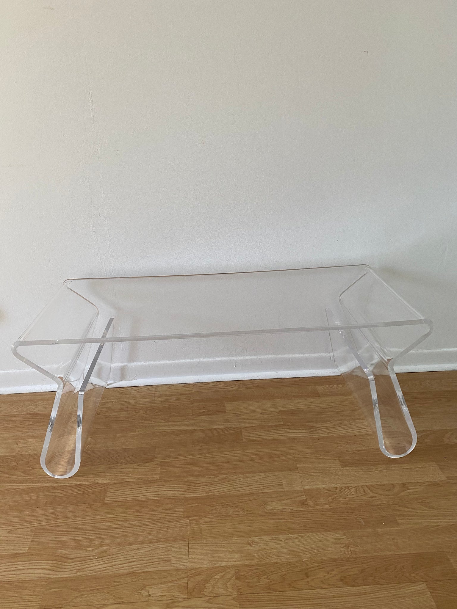 Curvy lucite waterfall coffee table