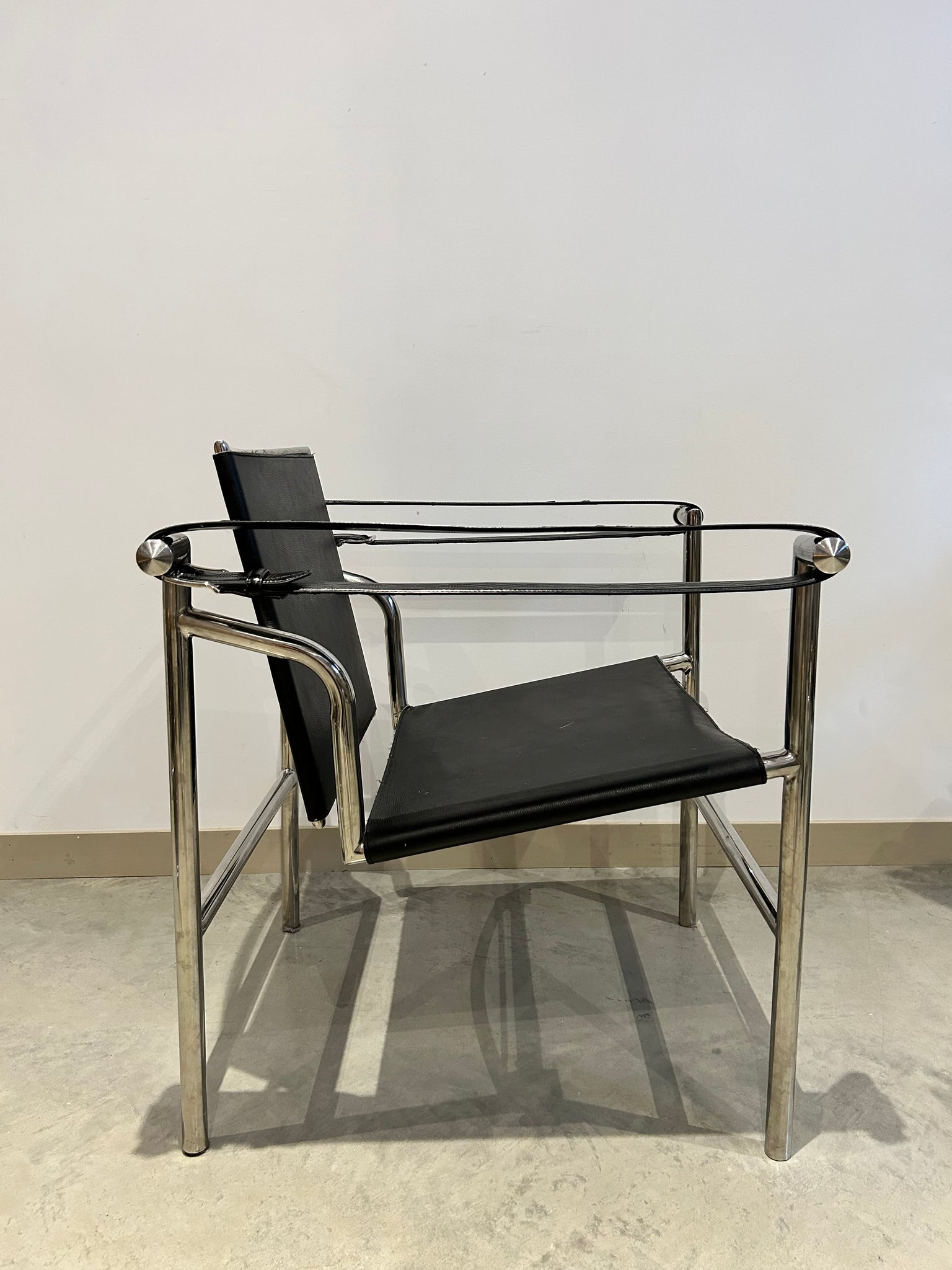 Black LC1 Le Corbusier sling armchairs