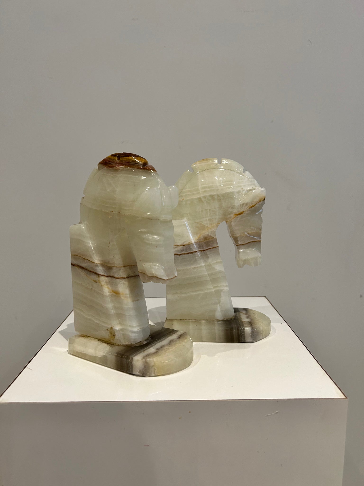 White marbled onyx horse book-ends