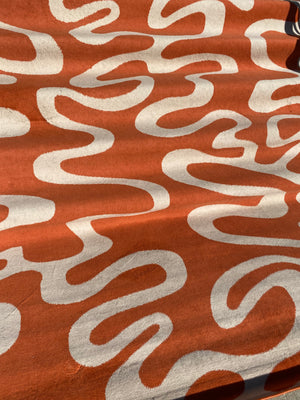 XL orange carpet with white squiggles