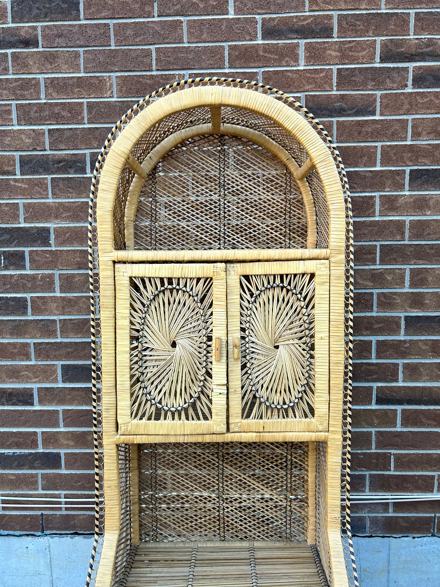 Tall sunburst wicker shelf with doors