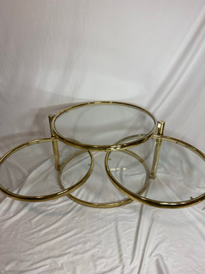 Golden brass & glass round swivel coffee table