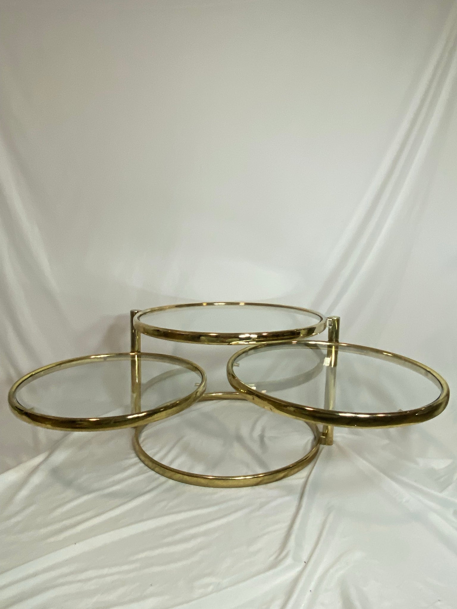 Golden brass & glass round swivel coffee table