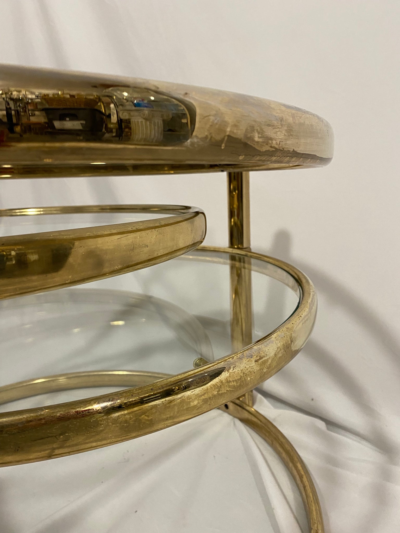 Golden brass & glass round swivel coffee table