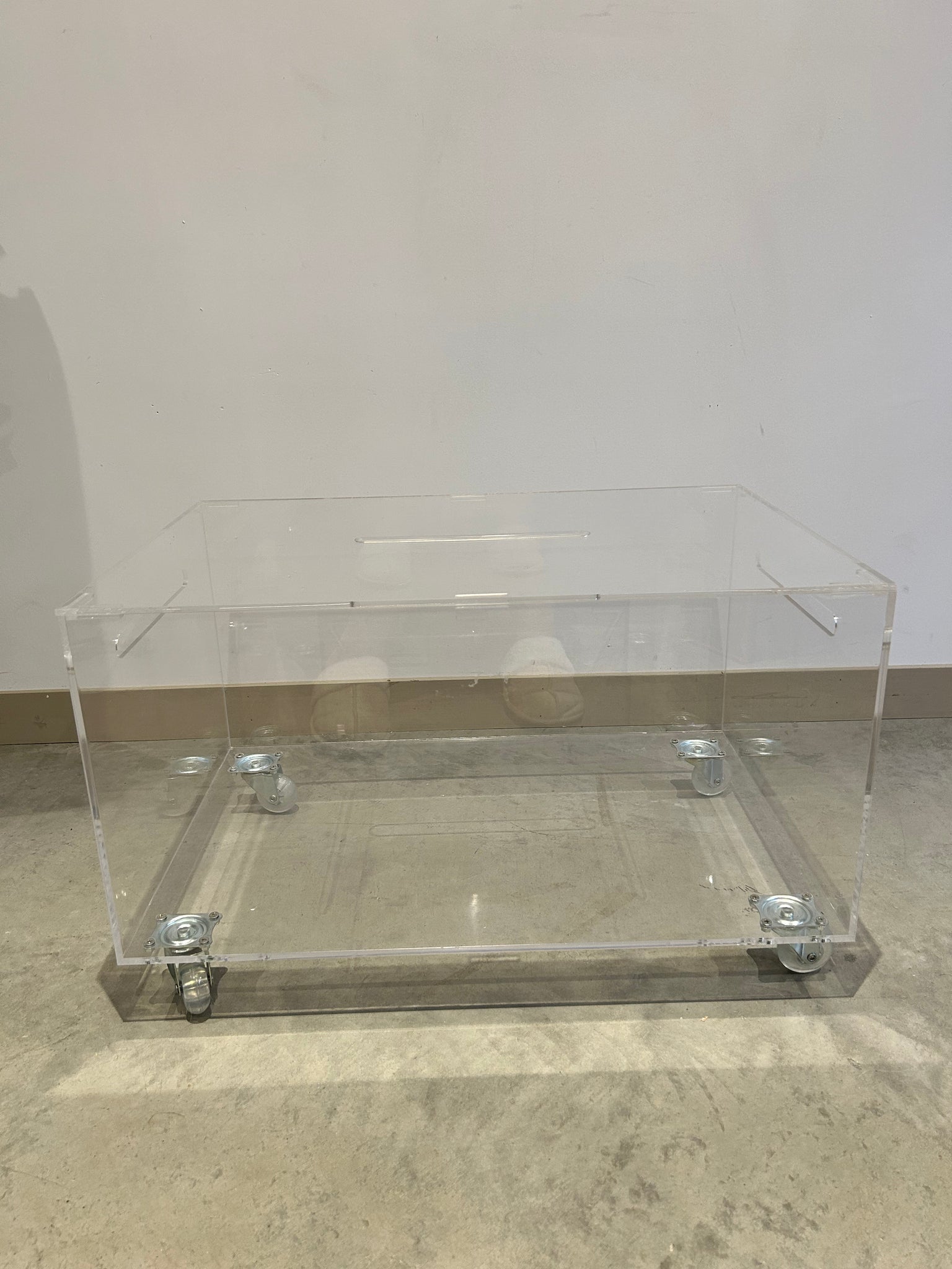 Small lucite coffee table with storage on wheels