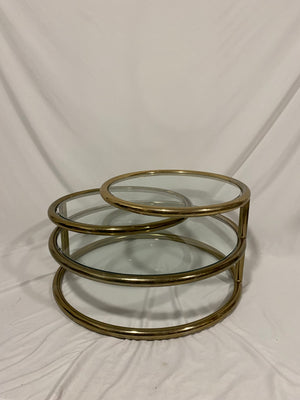 Golden brass & glass round swivel coffee table