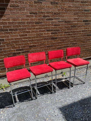 Bright red velvety & chrome cantilever bar stools