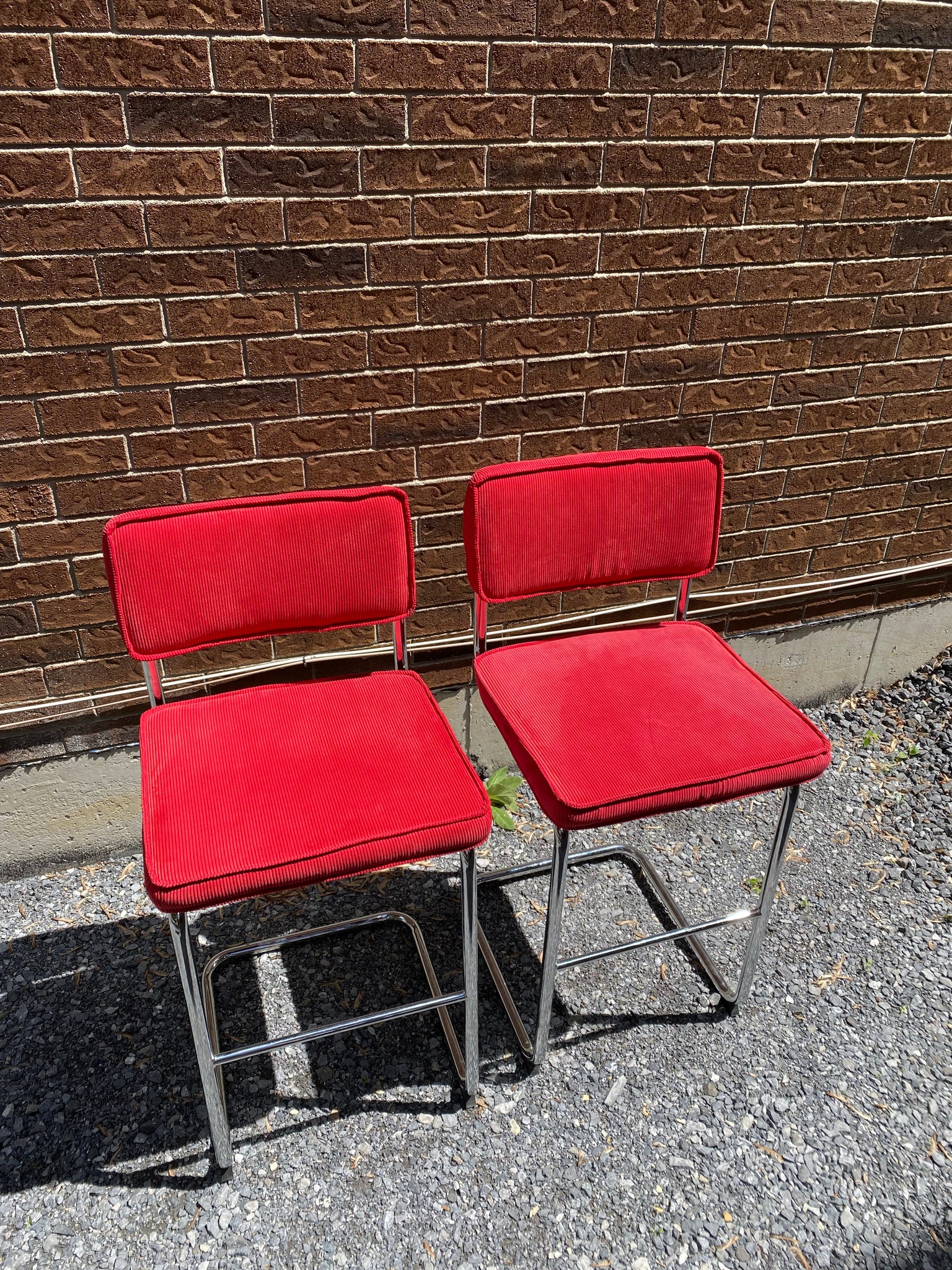 Bright red velvety & chrome cantilever bar stools