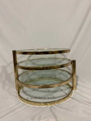 Golden brass & glass round swivel coffee table