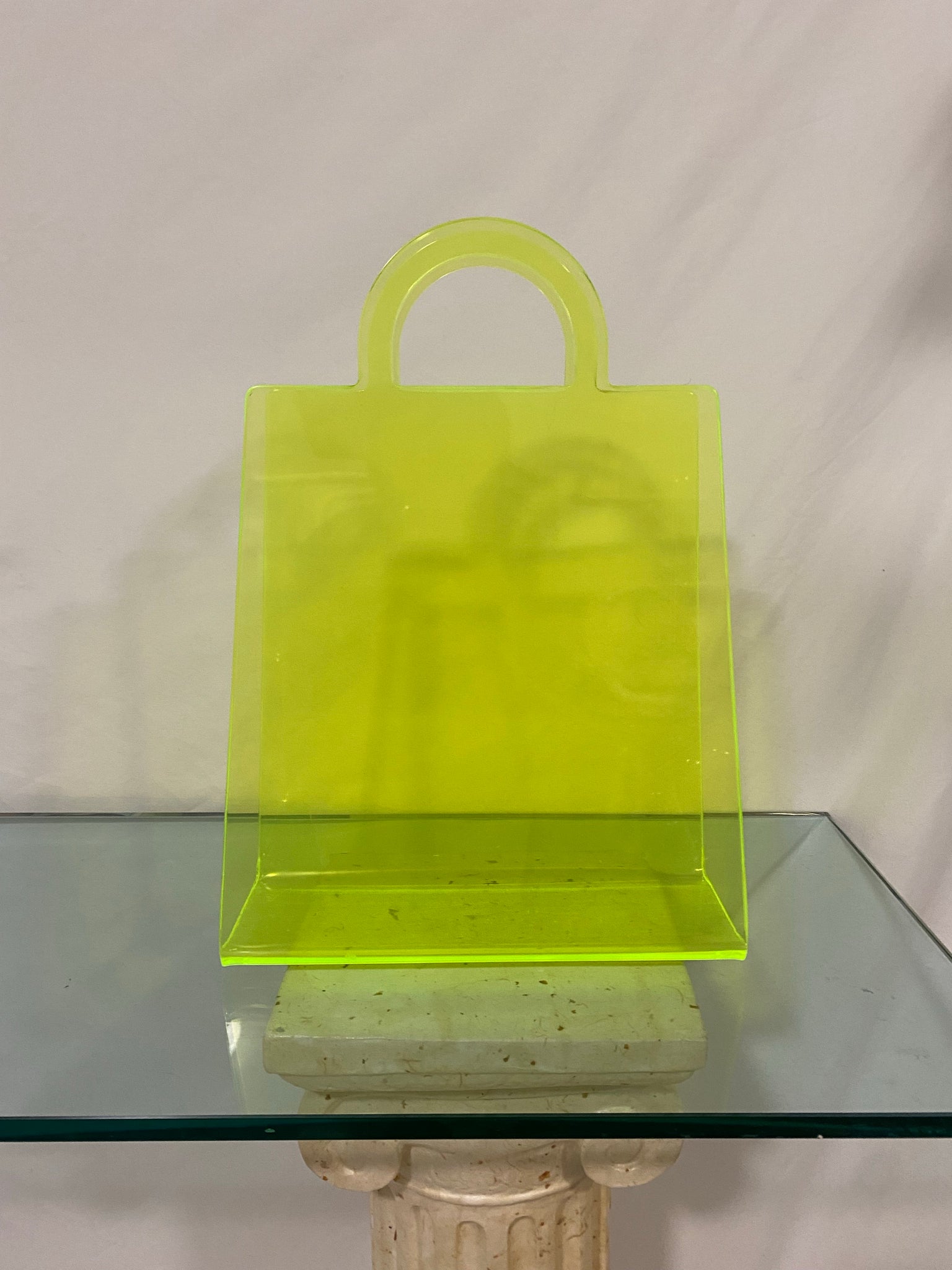 Neon yellow shopping bag shaped literature rack