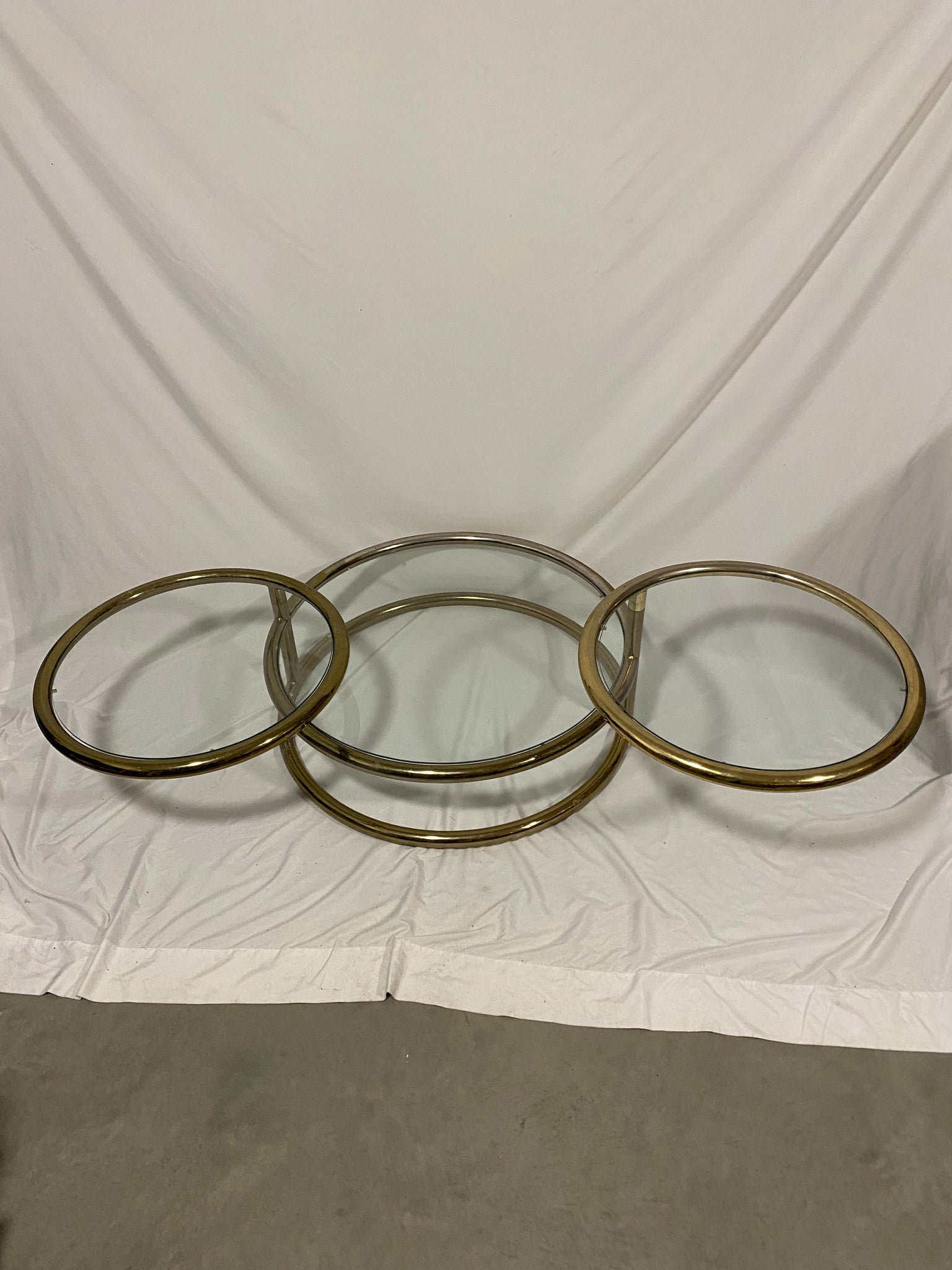 Golden brass & glass round swivel coffee table