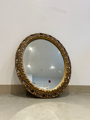 Antique ornate golden oval mirror