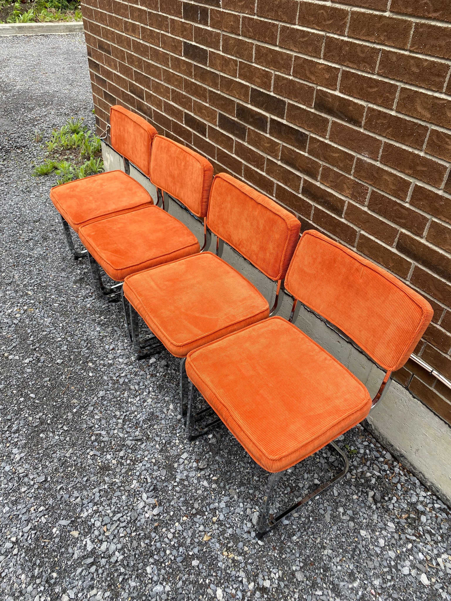 Bright orange velvety & chrome cantilever chairs