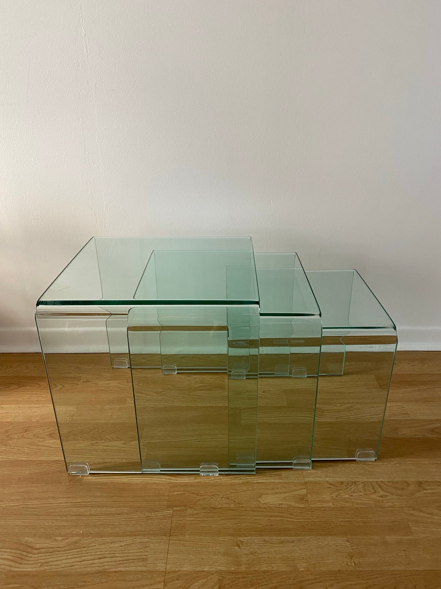 Trio of small tempered glass waterfall nesting side tables