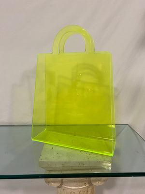 Neon yellow shopping bag shaped literature rack