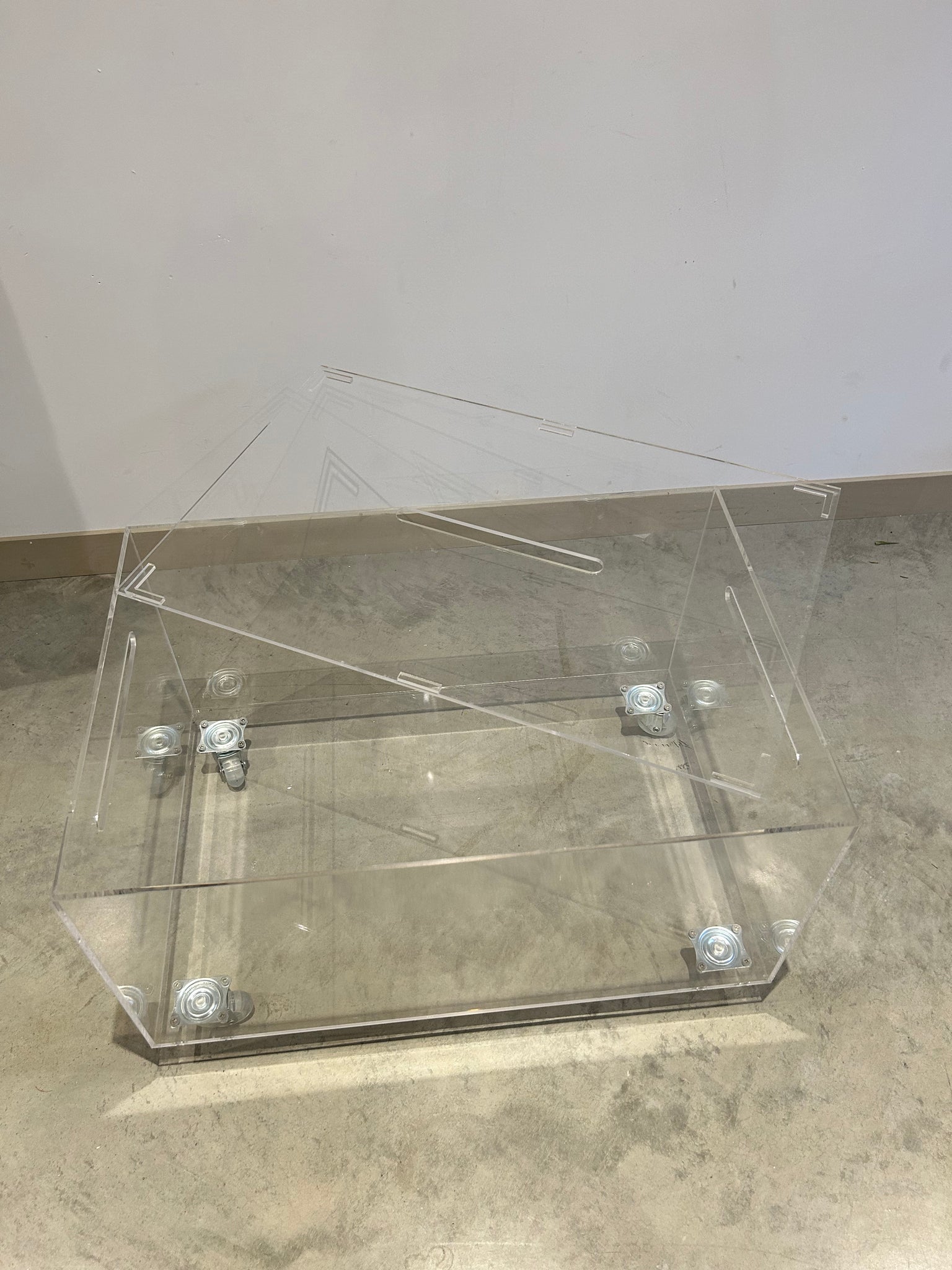 Small lucite coffee table with storage on wheels