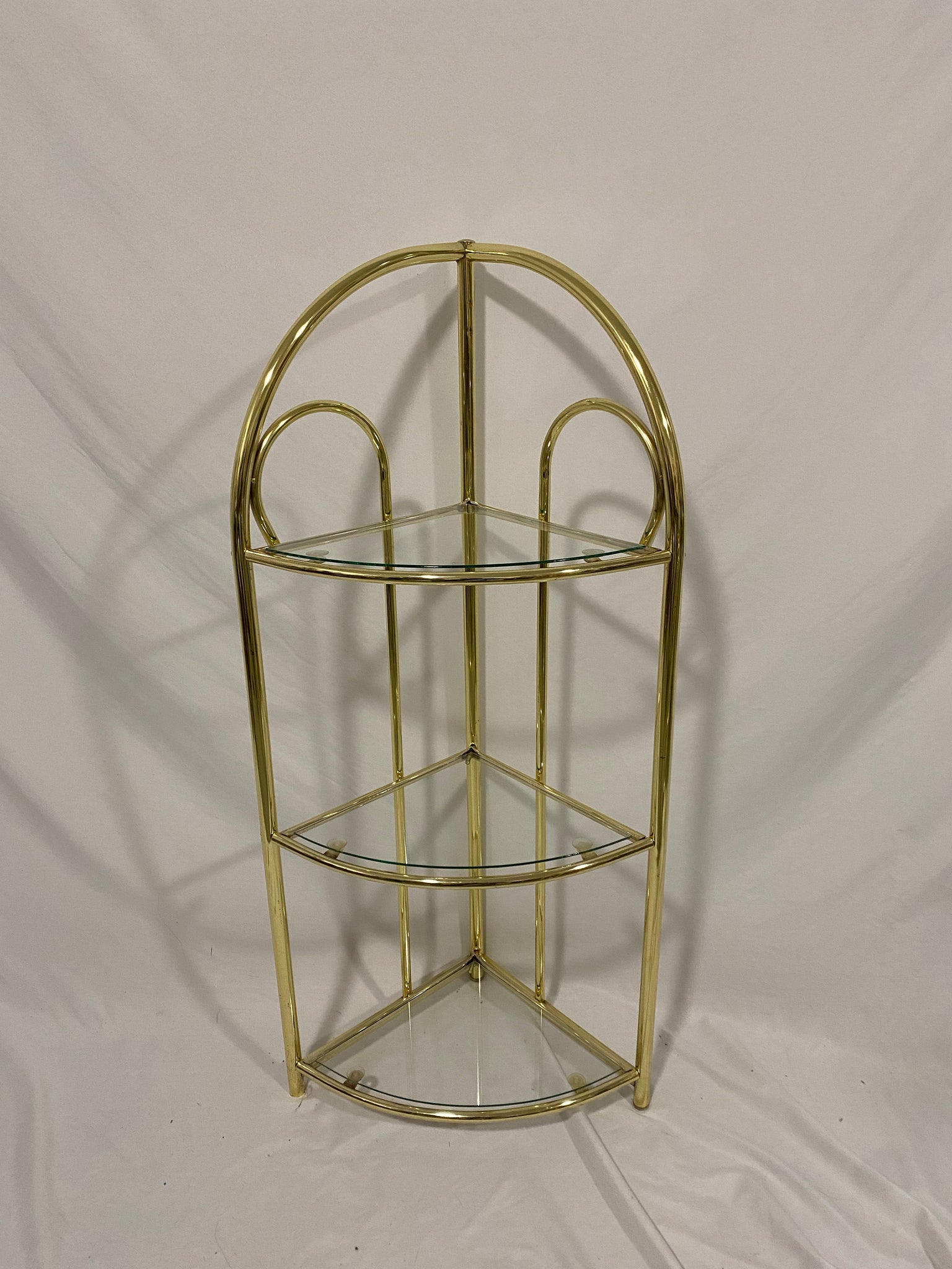 Small golden brass corner shelf